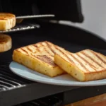 Slices of grilling cheese on a grill